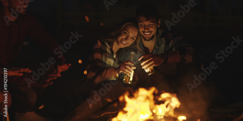 Couple enjoying with friends at night on the beach © .shock