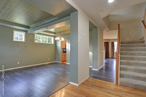 Spacious empty interior with dark grey hardwood floor