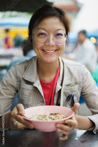 Asian woman eating crepe congree congree photo