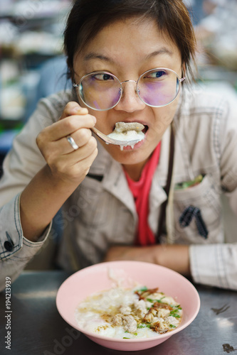 Asian woman eating crepe congree photo