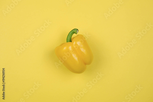 Yellow pepper on yellow background photo