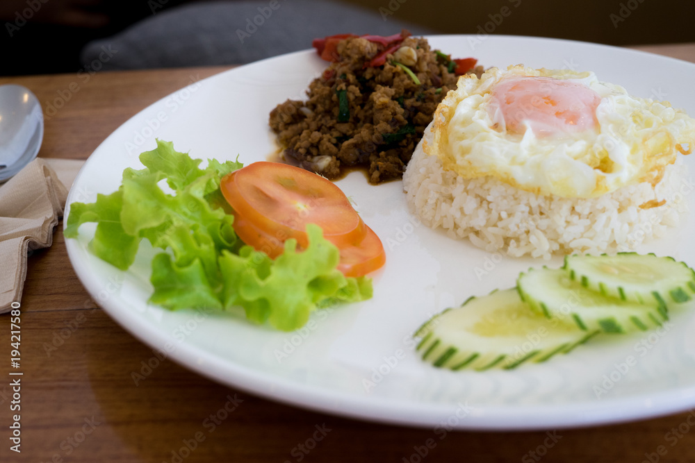 Fried basil leave with pork, squid, shrim, chicken, meat, crisp pork, chicken innards, combination on rice.