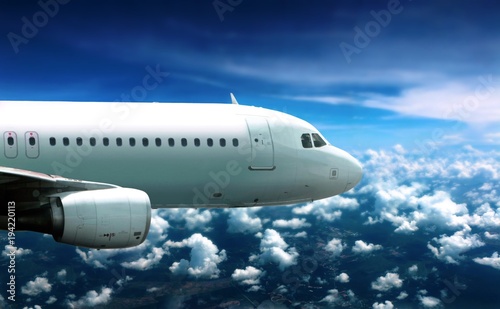 Airplane flying in cloudy sky below