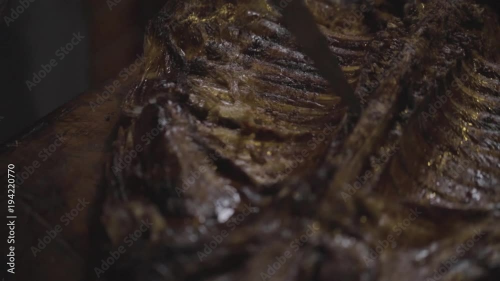 Carving cooked ribs, meat, butchering, butchery Carving cooked ribs, meat, butchering, butchery