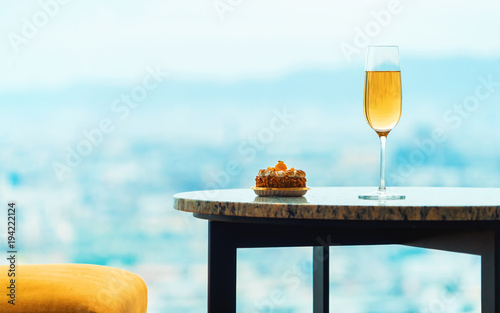 Gourmet pastries with white wine in a room high above the city