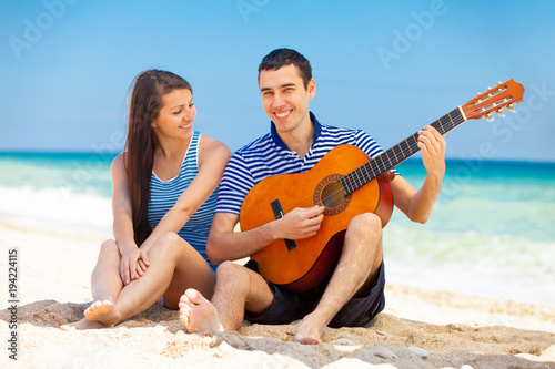 in love couple in blue clothes with guitar