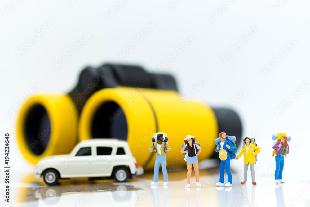 Fototapeta premium Miniature people: Travelers standing on a world map with binoculars. Image use for travel , business concept.