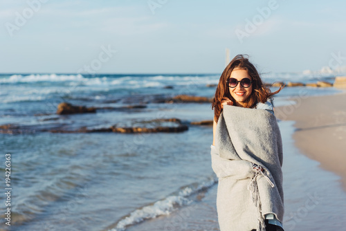 Young beautiful girl posing by the sea