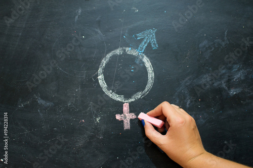 Gender symbols or signs for the male and female sex drawn on a blackboard photo