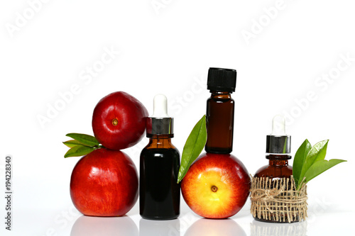peach  oil.natural peach   oil in dark glass bottles and fresh peach fruit on white background