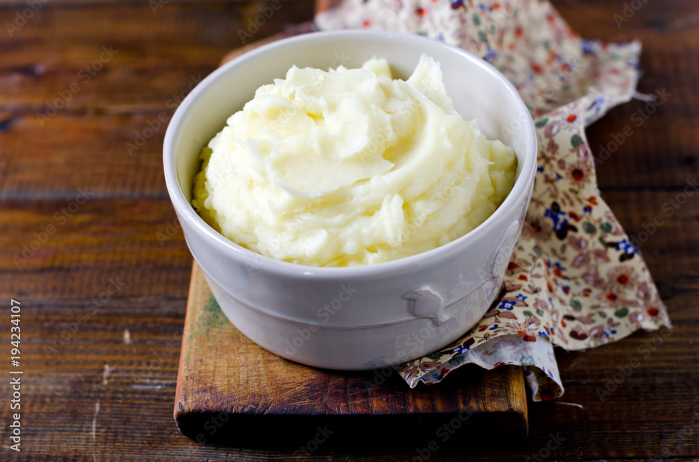 Mashed potatoes in a bowl on a wooden table Mashed potatoes in a bowl on a wooden table