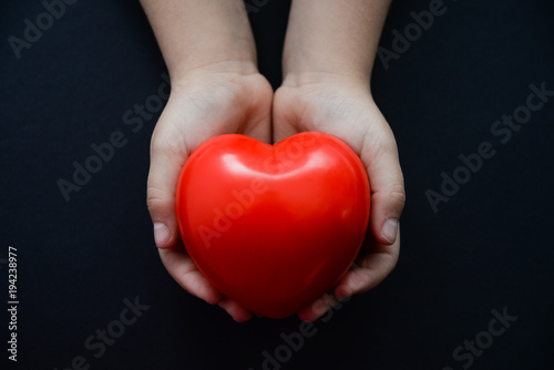 little child hands with a heart