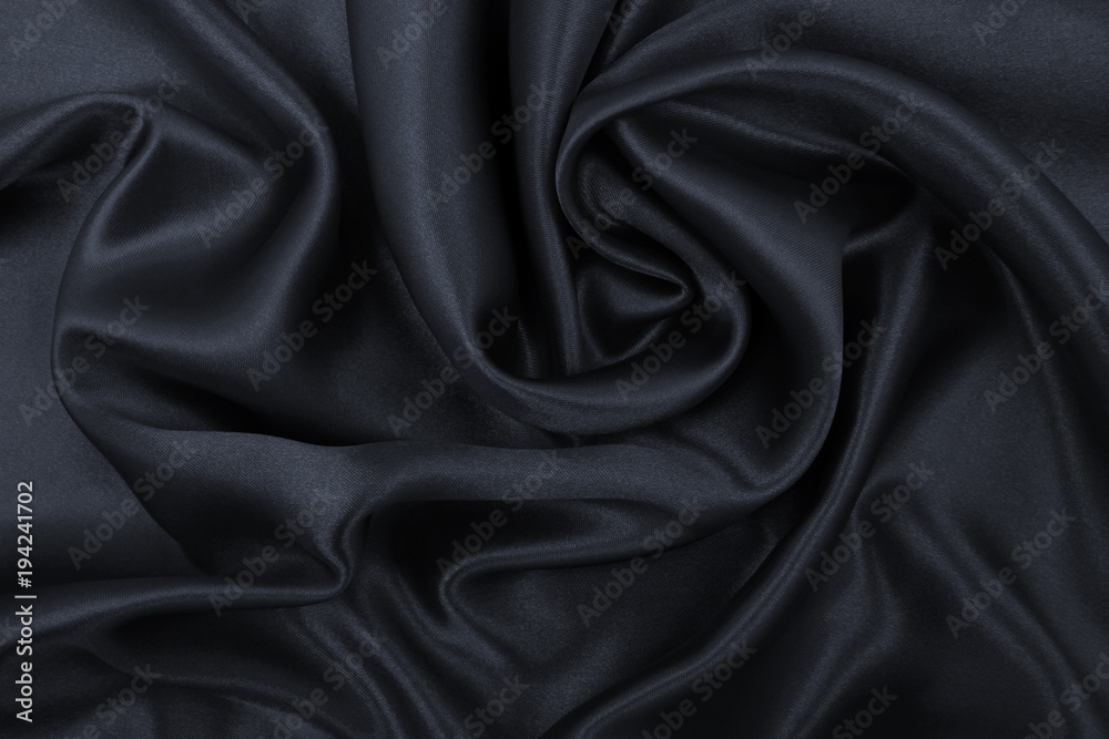 Smooth elegant dark grey silk or satin texture as abstract background. Luxurious background design