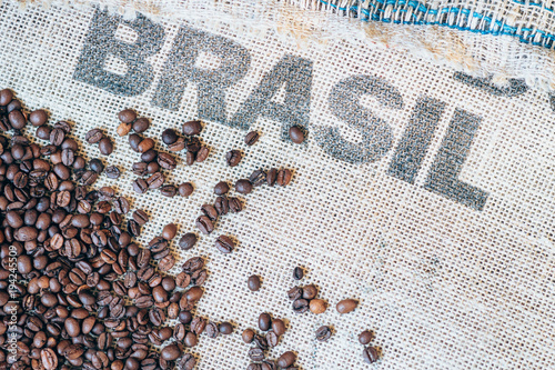coffee beans on jute sack and printed Brasil on background