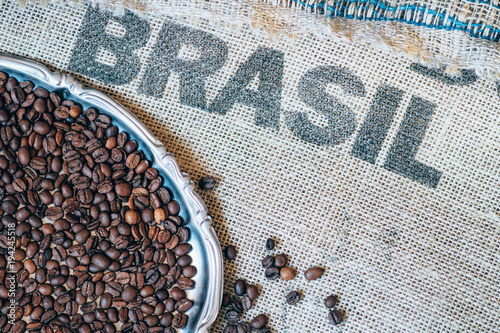 coffee beans on jute sack and printed Brasil on background