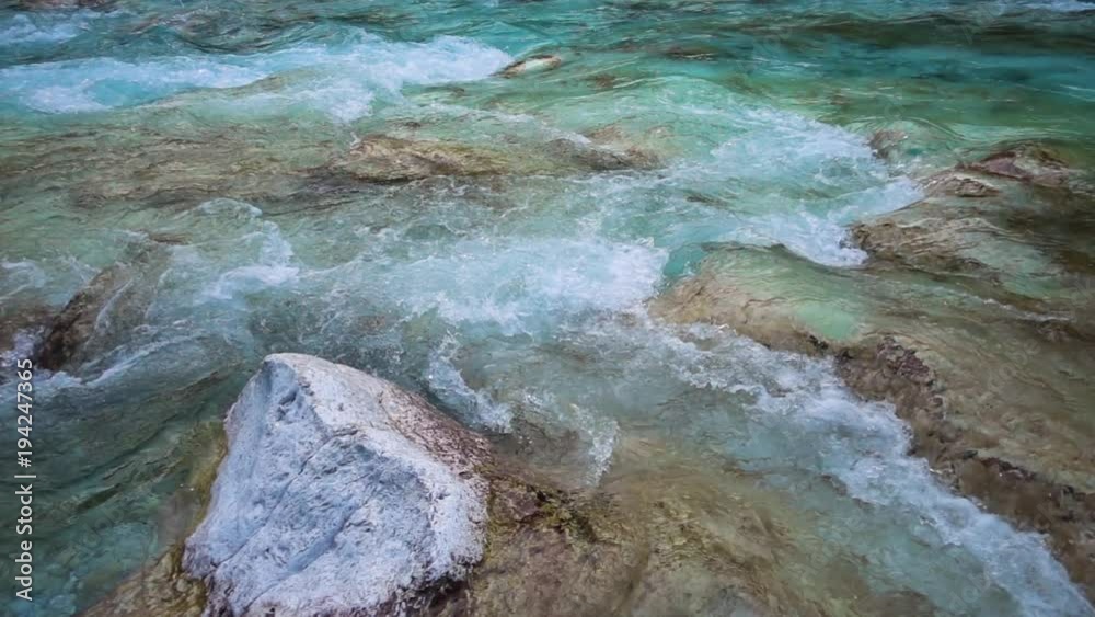 SLOW MOTION: flowing water over stones in mountines river SLOW MOTION: flowing water over stones in mountines river