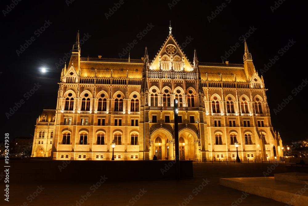 Hungarian Parliament Building At Full Moon Night In Budapest, Hungary