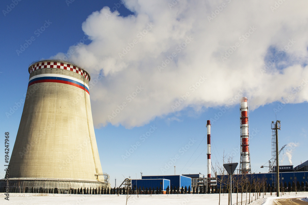 Thermoelectric power station with smoke pipe on the background of blue sky. Thermoelectric power station with smoke pipe on the background of blue sky.