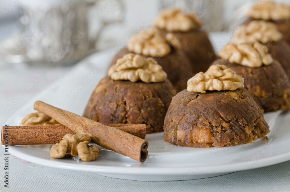 Fototapeta premium Traditional Turkish sweet dessert halva with walnut on the white plate