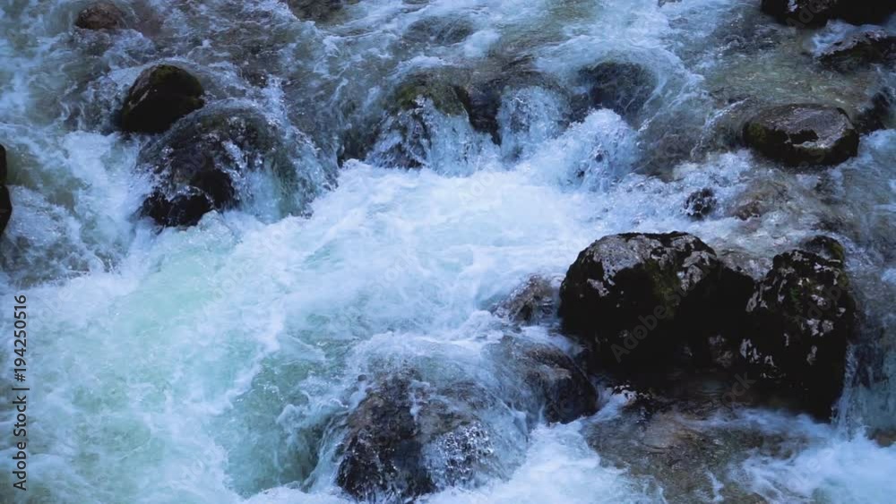 SLOW MOTION: flowing water over stones in mountines river