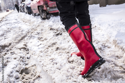 Girl in red boots in deep snow. Winter concept