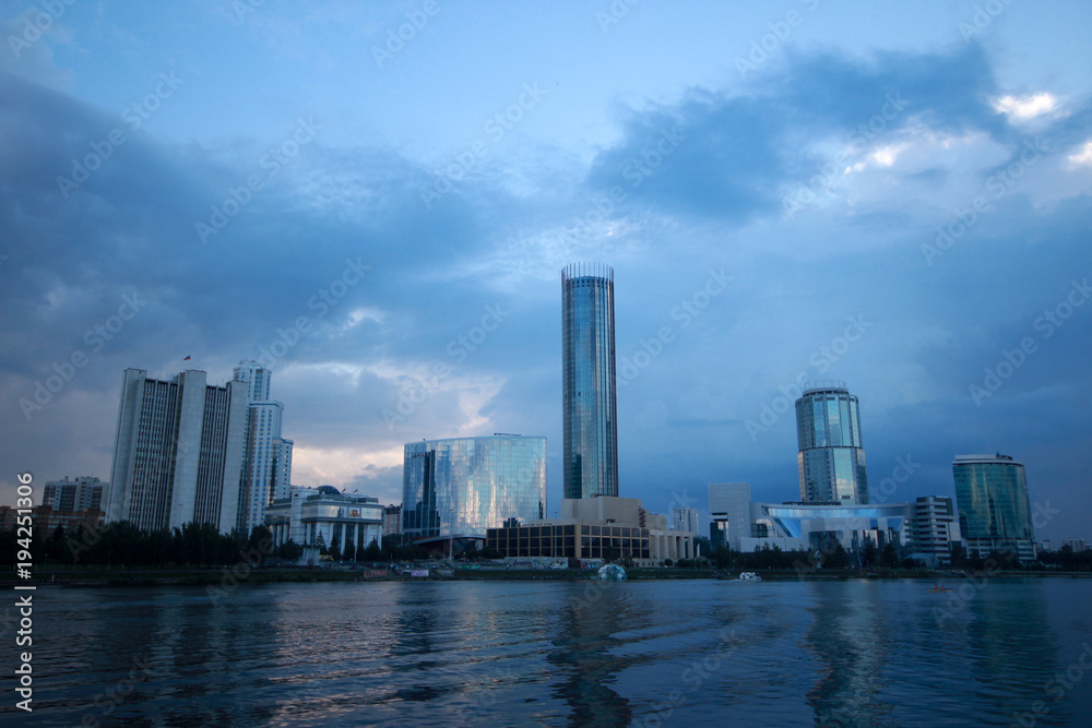 Ekaterinburg city, view from the embankment to the skyscrapers in the bright blue twilight