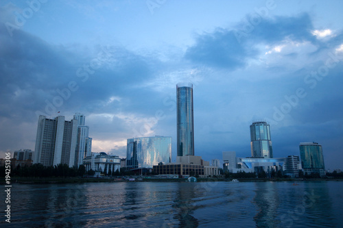 Ekaterinburg city, view from the embankment to the skyscrapers in the bright blue twilight