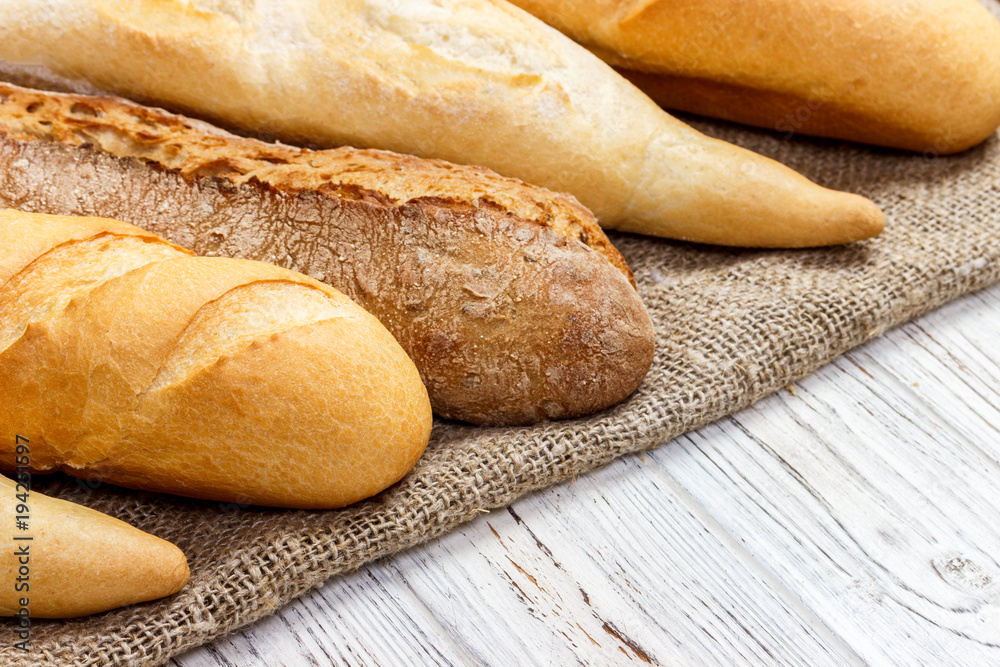 different types of baguette on a wooden background