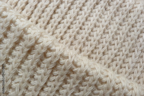 knitted scarf close-up beige knitted fabric yarn wool acrylic cotton natural thread close-knit vintage background for decoration hand-made background made by hand