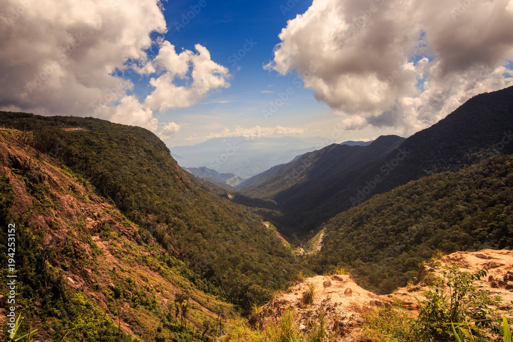 Naklejka premium Shallow Wooded Canyon Walkway Cloud Shadows on Hill Tops