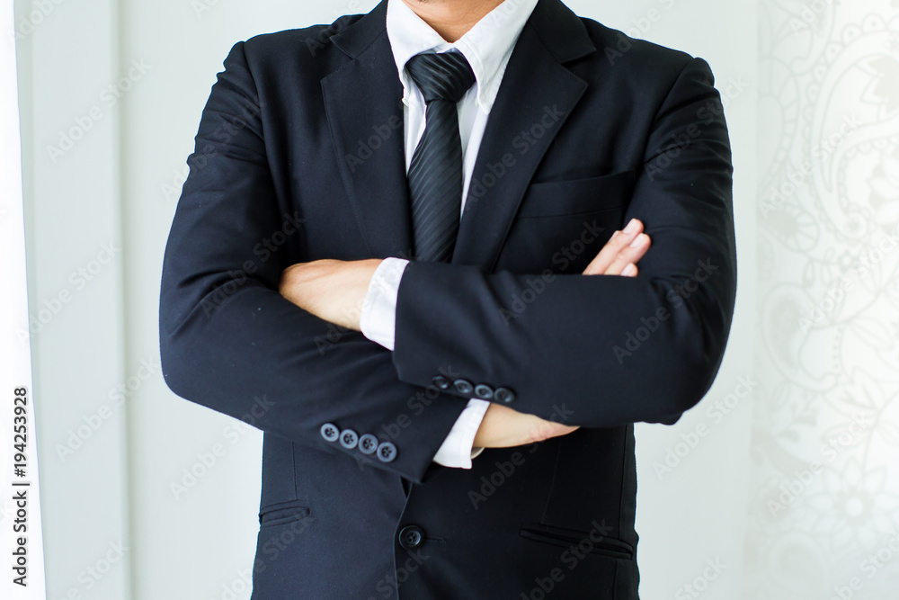 People, business,fashion and clothing concept - close up of man in shirt dressing up and adjusting tie on neck at home. People, business,fashion and clothing concept - close up of man in shirt dressing up and adjusting tie on neck at home.