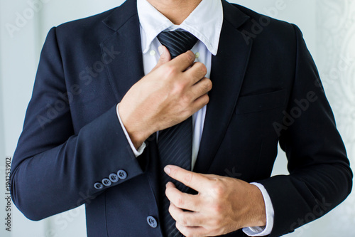 Tela People, business,fashion and clothing concept - close up of man in shirt dressing up and adjusting tie on neck at home