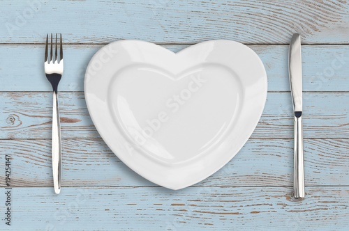 empty heart plate top view on blue wood table photo