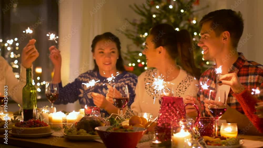 friends celebrating christmas at home dinner party