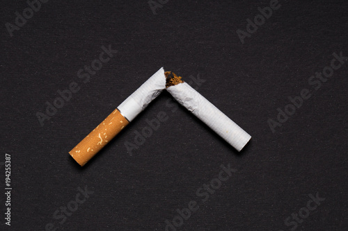 broken cigarette on a black background photo