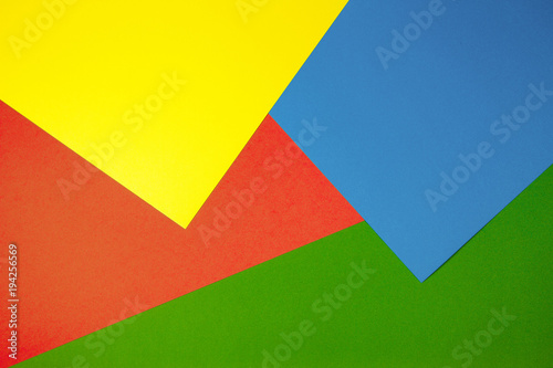 Color papers geometry flat composition background with yellow, green, red and blue tones