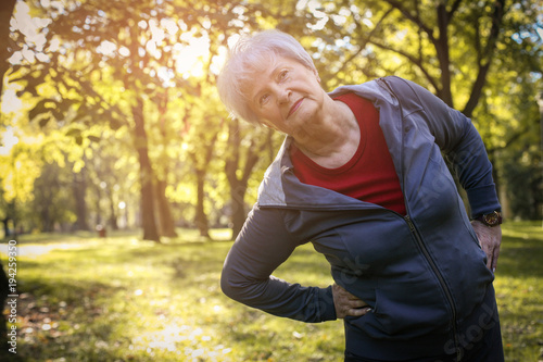 Active senior woman working exercise and stretching back.