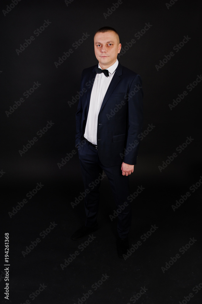 Stylish man in suit posed on studio isolated on black. Stylish man in suit posed on studio isolated on black.