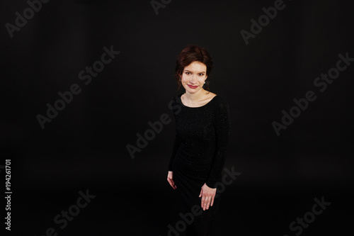 Elegance woman in black evening dress posed on studio isolated on black. © AS Photo Family