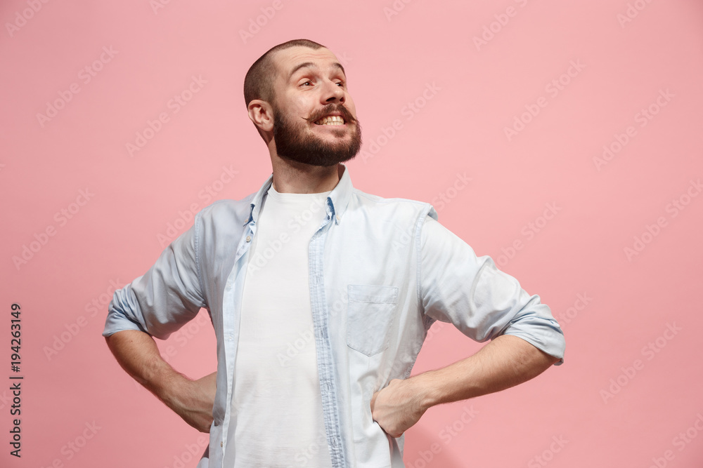 The happy business man standing and smiling against pastel background. The happy business man standing and smiling against pastel background.
