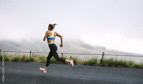 Woman athletes running on road