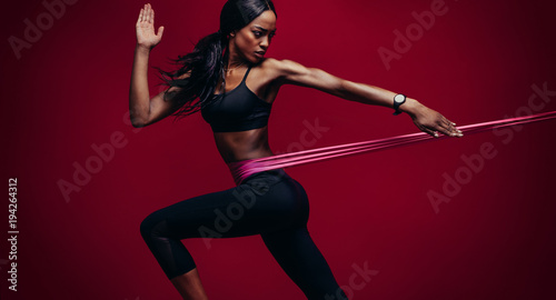 Strong woman using a resistance band in her exercise routine