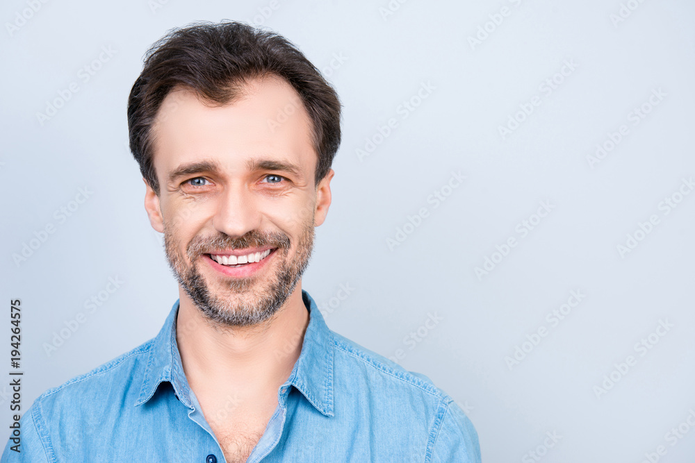 Fototapeta premium Close up front view portrait of mature cheerful excited satisfied glad virile masculine man wearing jeans denim shirt isolated on gray background empty blank place copyspace