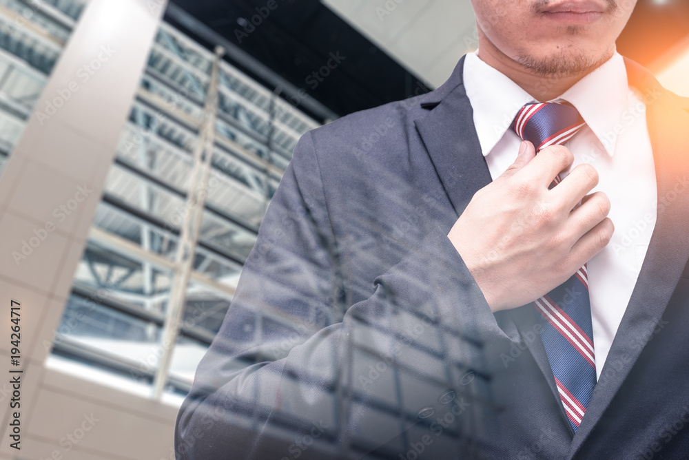 The double exposure image of the business man wearing the siut during sunrise overlay with cityscape image. The concept of modern life, business, personality, suit and lifestyle. The double exposure image of the business man wearing the siut during sunrise overlay with cityscape image. The concept of modern life, business, personality, suit and lifestyle.