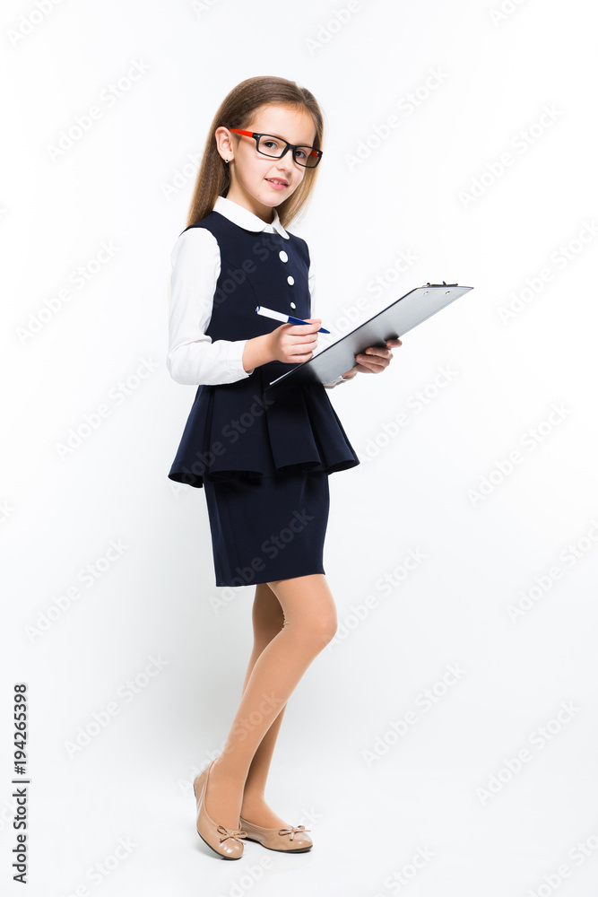 Little girl with pen and clipboard in her hands dressed as a businesswoman Little girl with pen and clipboard in her hands dressed as a businesswoman