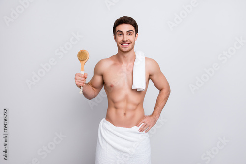 Handsome, attractive guy with bristle, stubble and towel on shoulder, presenting fetlock in arm, looking at camera, isolated on white background, purity, clean, clear concept photo