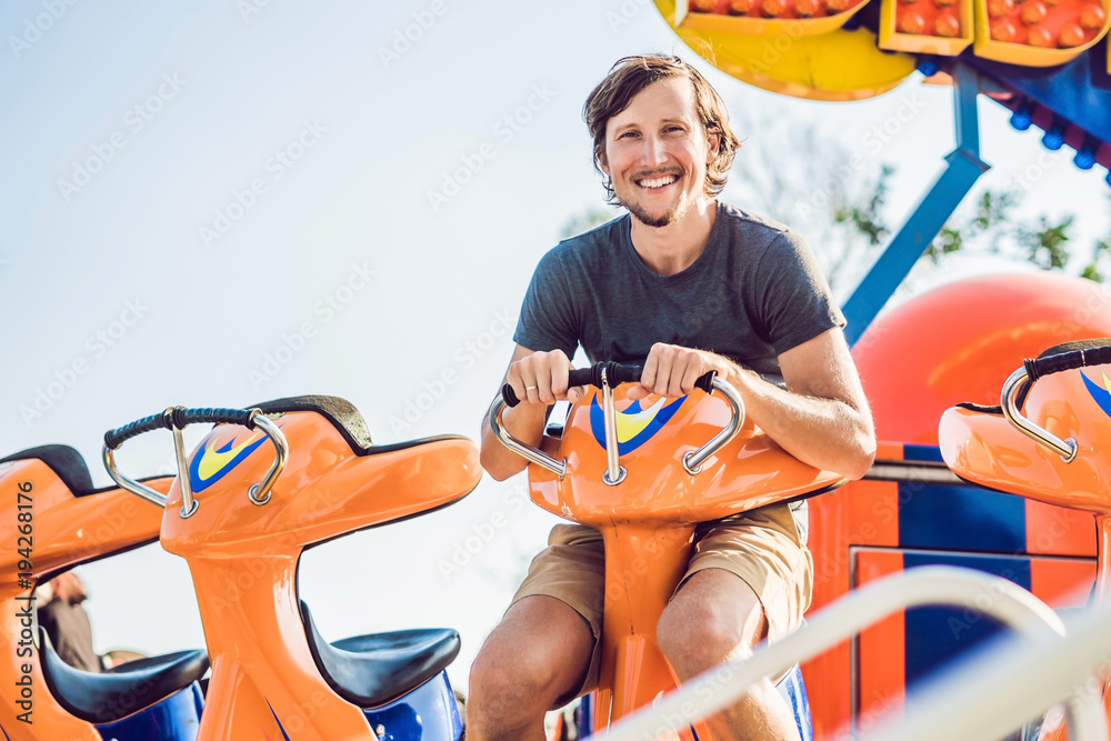 Beautiful, young man having fun at an amusement park