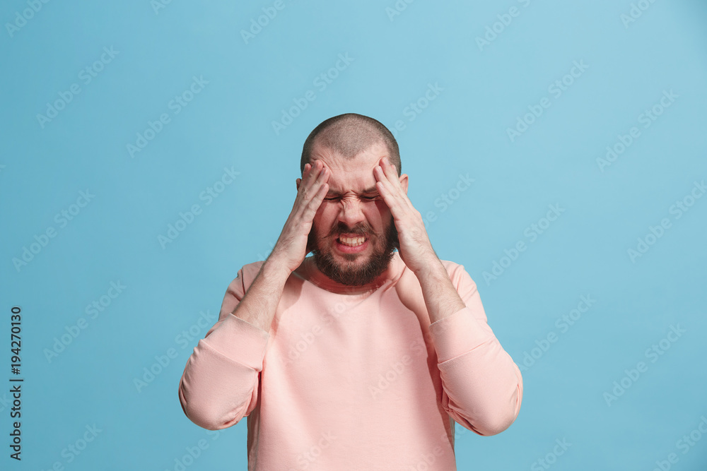 Man having headache. Isolated over blue background. Man having headache. Isolated over blue background.
