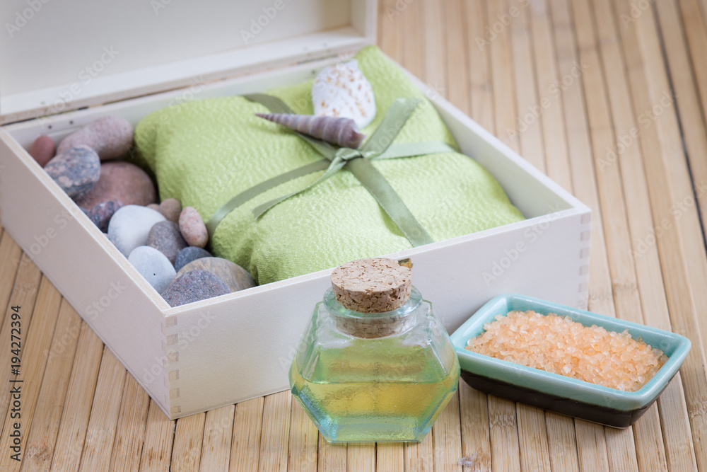 Healthy outfit for relaxation and SPA procedures with towel, stones and body oil Healthy outfit for relaxation and SPA procedures with towel, stones and body oil