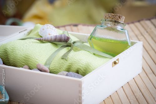 Healthy outfit for relaxation and SPA procedures with towel, stones and body oil